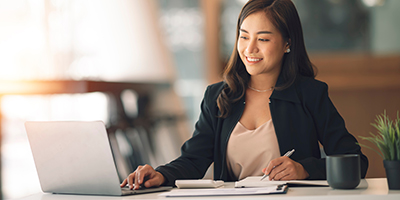 Woman going over billing accounts on a computer.