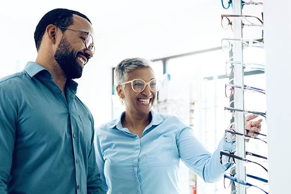 Couple looking at eyeglass frames.